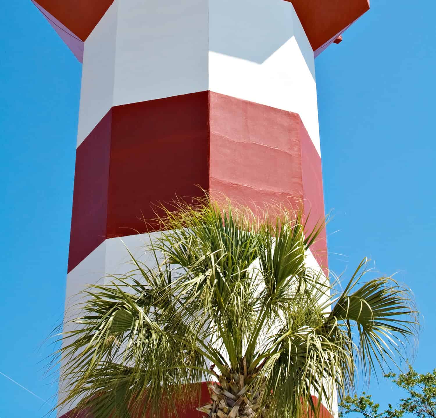 A clear blue sky features the Harbour Town Lighthouse - famous landmark in Hilton Head, SC, USA
