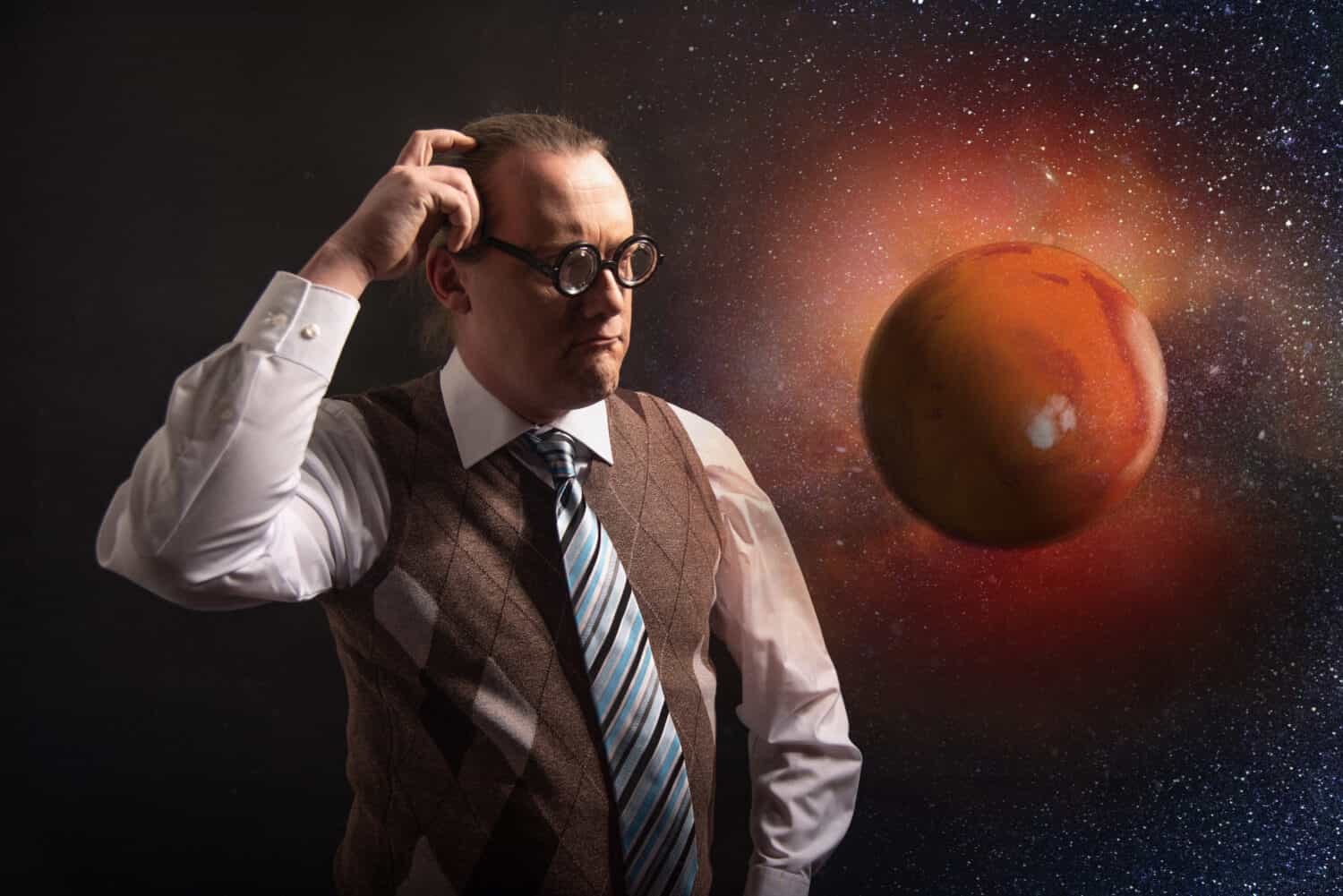 Funny scientist looking to universe and planet mars