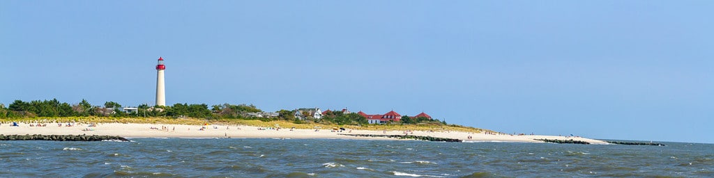 Panorama of beach with Cape May Lighthouse in Cape May, New Jersey.
