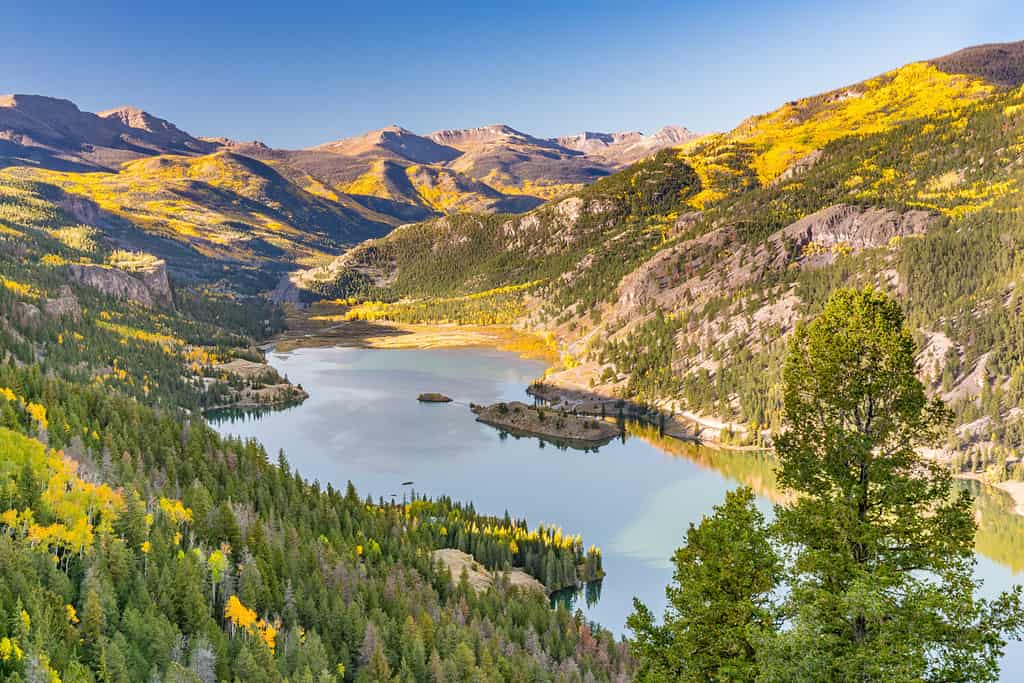 Aerial view of Lake San Cristobal during autumn, nestled in the scenic Rocky Mountains of Colorado. 