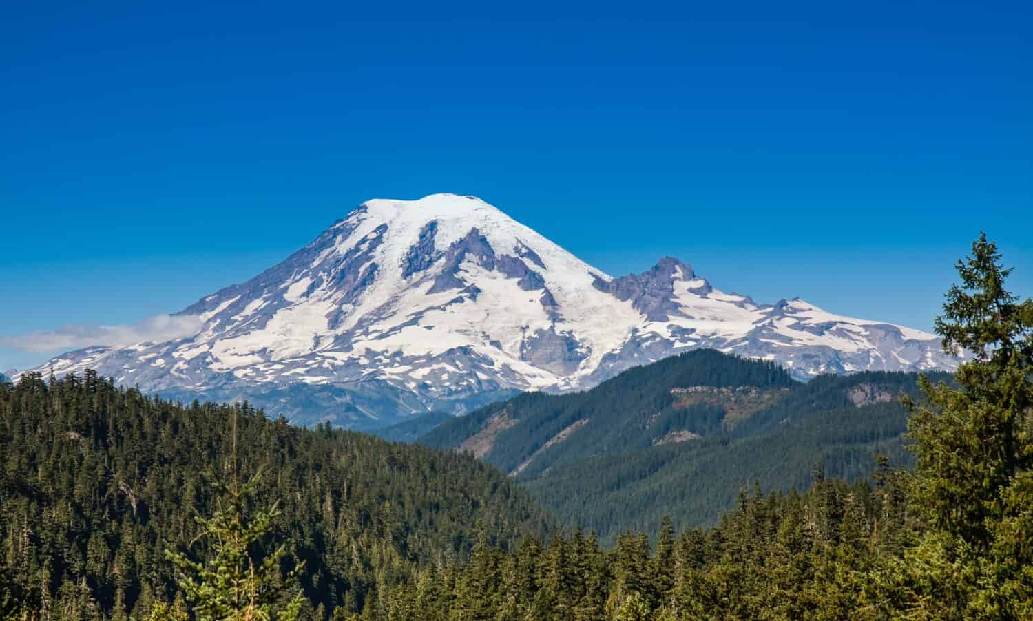 Mount Rainier towers over the surrounding mountains sitting at an elevation of 14,411 ft. It is considered to be one of the world's most dangerous volcanoes.