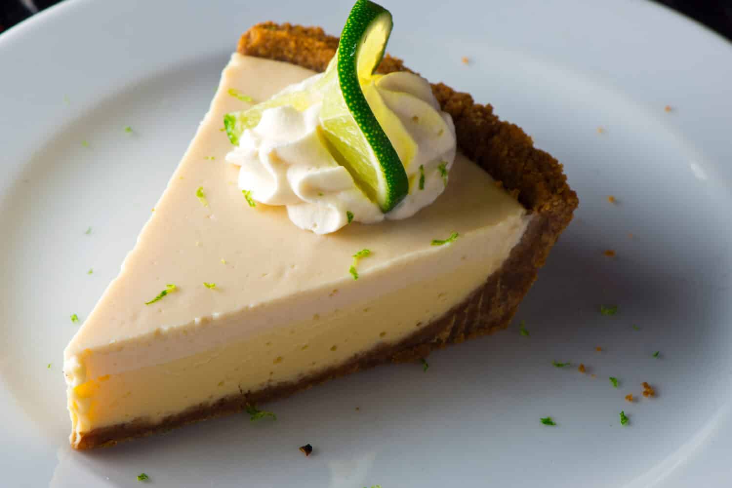 Key Lime Pie. Classic traditional American dessert favorite. Key lime pie, raw mixture made with the juice from Key West lime juice, condensed milk sugar and eggs poured into graham cracker crust. 