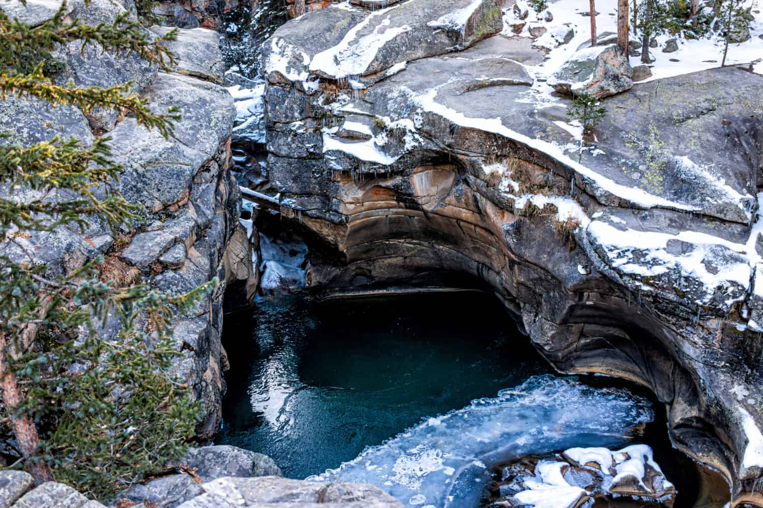 Independence Pass snow area rocky mountain closeup view of grottos cave pool near scenic byway in morning near Aspen, Colorado