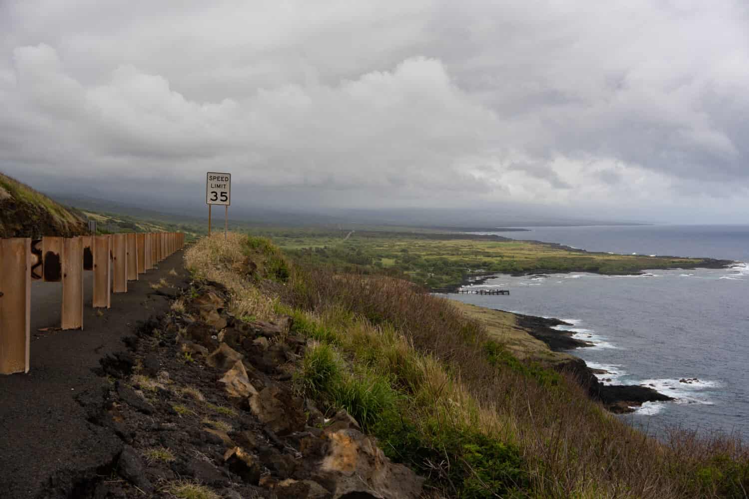 This is the scenic Route 11 in Hawaii. The is part of the Hawaii belt rode. Picture is overlooking the coast and black sand beach as a storm approaches. 