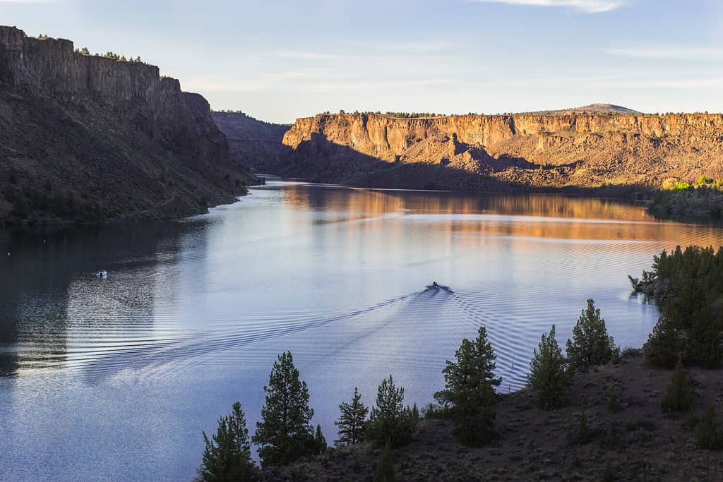 Motor boat on the beautiful lake at sunset. Billy Chinook lake in Oregon, USA, The Cove Palisades State park