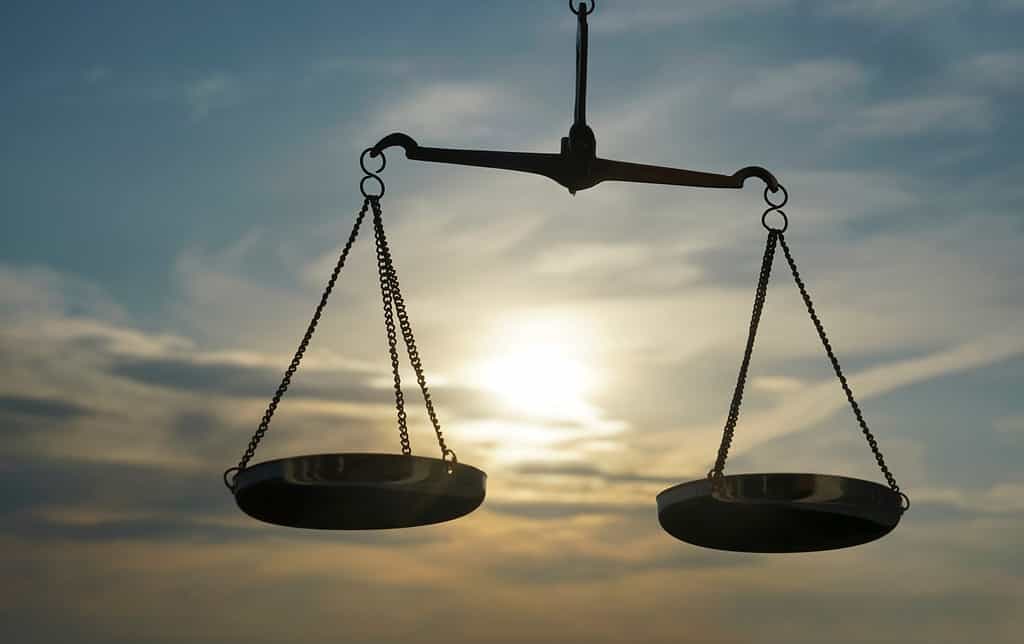 Scales of Justice background - legal law concept. a balance is hand-held, sky is the background.zodiac sign - libra