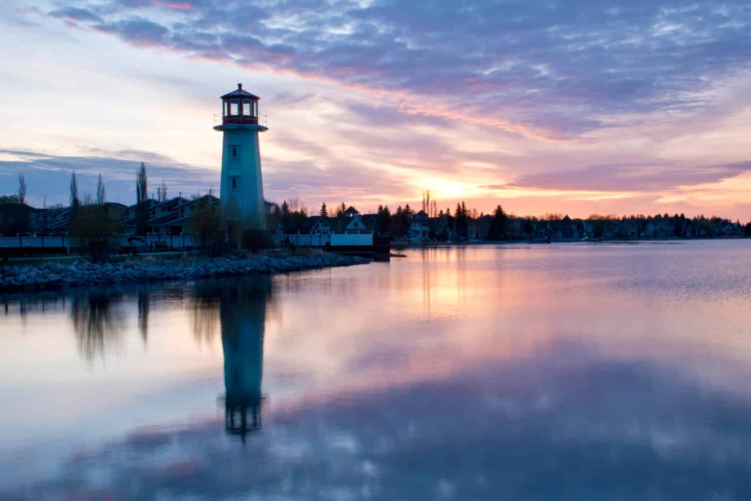  A lighthouse at the shore of Sylvan Lake Community on Alberta, Canada as a symbol of community building. A religious concept of light will reveal anything in darkness.