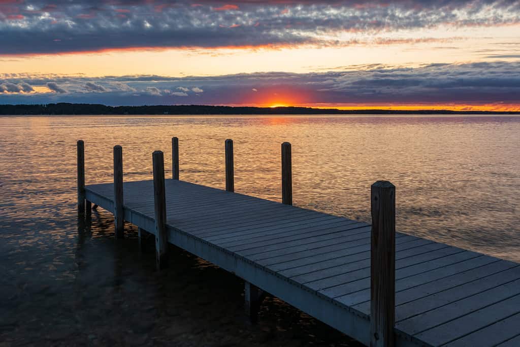 Sunset over dock on Torch Lake, Michigan.