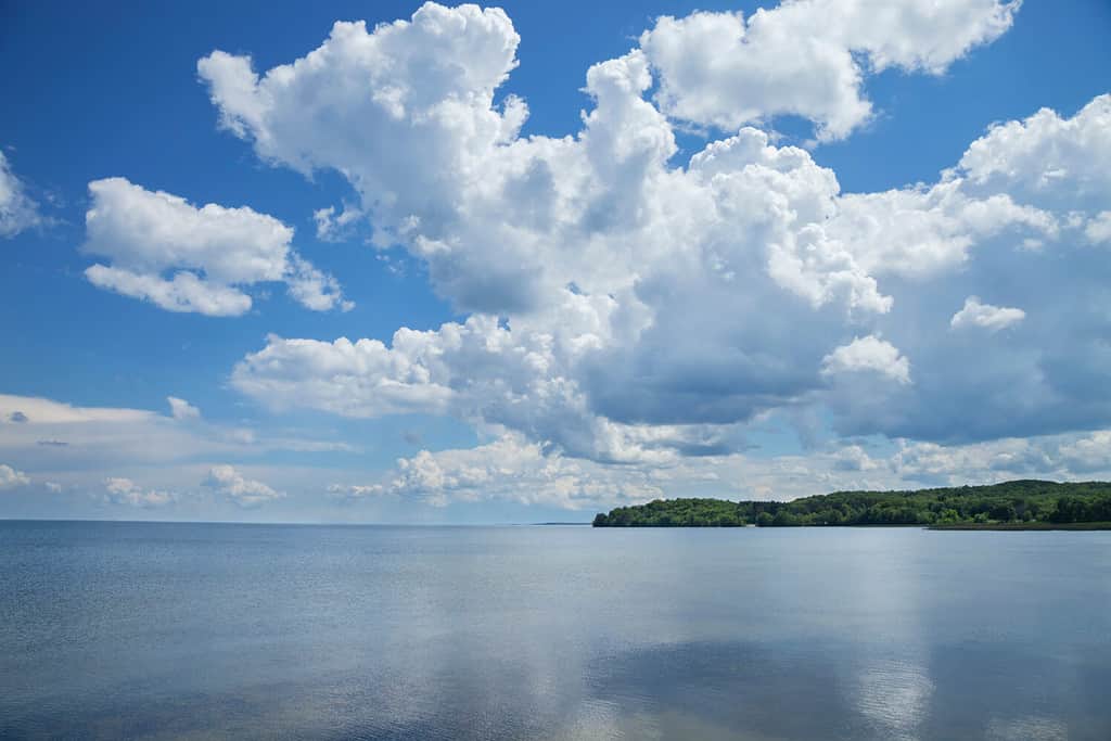 Mille Lacs Lake southwest side below dramatic clouds in north central Minnesota on a sunny summer afternoon