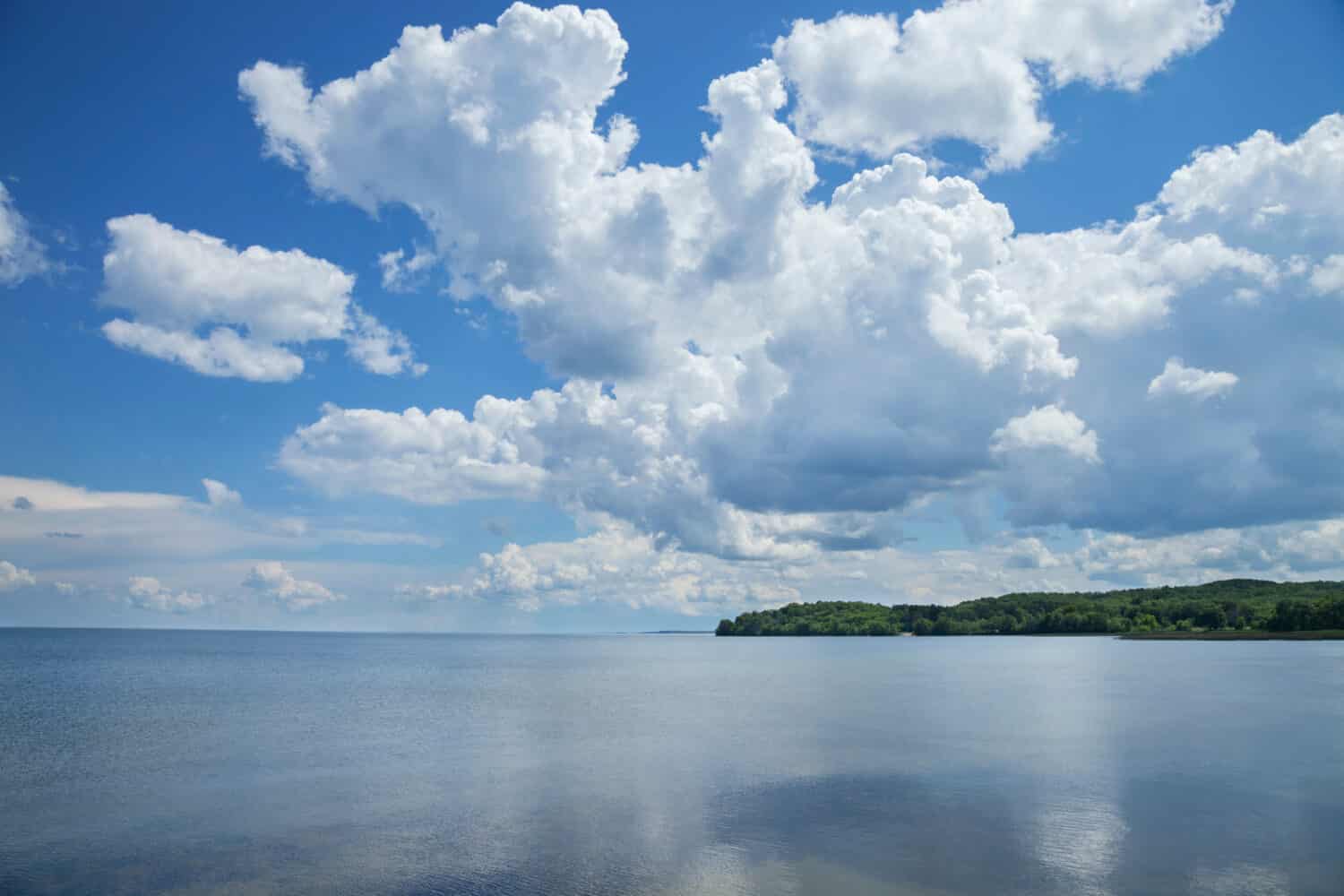 Mille Lacs Lake southwest side below dramatic clouds in north central Minnesota on a sunny summer afternoon