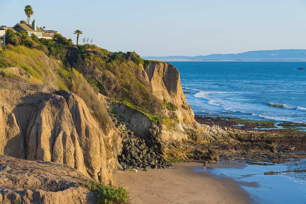Pismo Beach cliffs at sunset and ocean view with clear blue sky in the background, California Central Coast