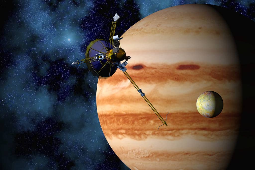 Jupiter, Io, and the Galileo space Probe with star field background. 3D computer-generated image.