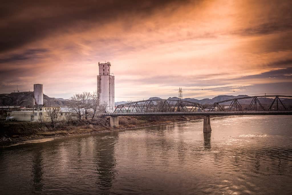 Yellowstone River Flowing Through Industrial Landscape with Rose Sunset - Glendive, Montana.