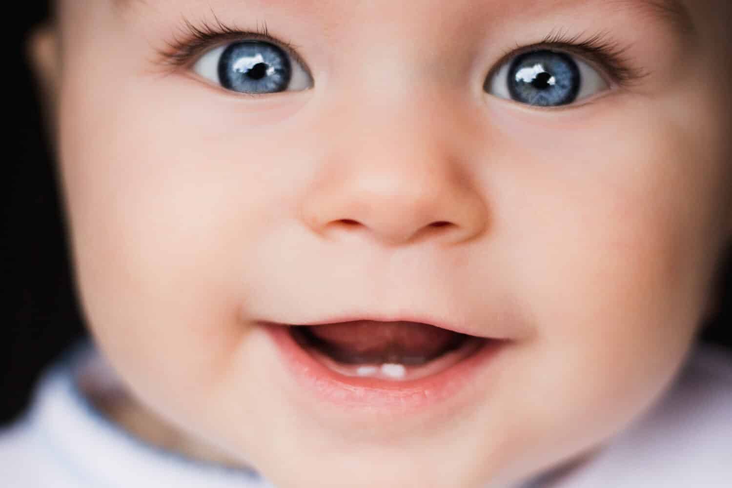 Baby portrait. Closeup face with bright blue eyes. Babies, eyes, ophthalmology, curiosity, happiness, explore the world, joy, childhood, psychology, parenthood, portrait concepts