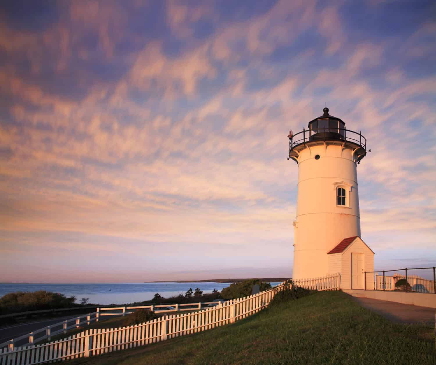 The Nobska Point Lighthouse Tower Bathed In Early Morning Sunlight, Woods Hole, Cape Cod, Massachusetts. USA