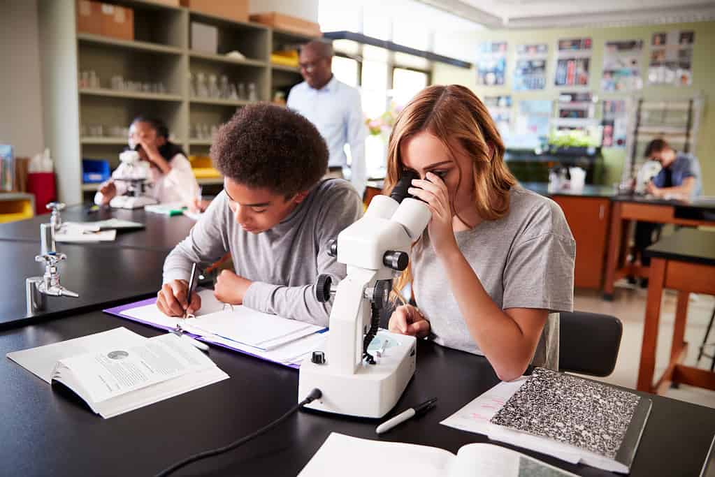 Students at Garfield High School California studying under a microscope. 