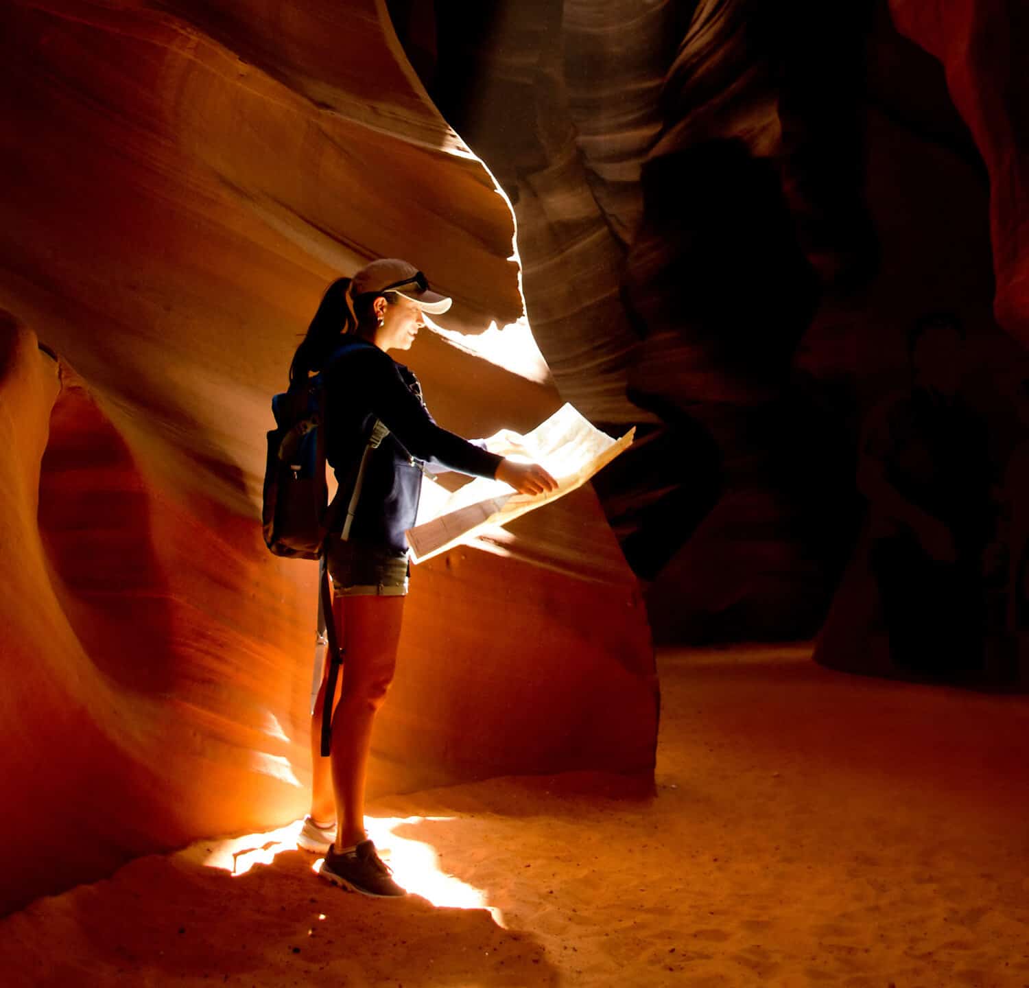 Female explorer inside a cave at the Grand Canyon