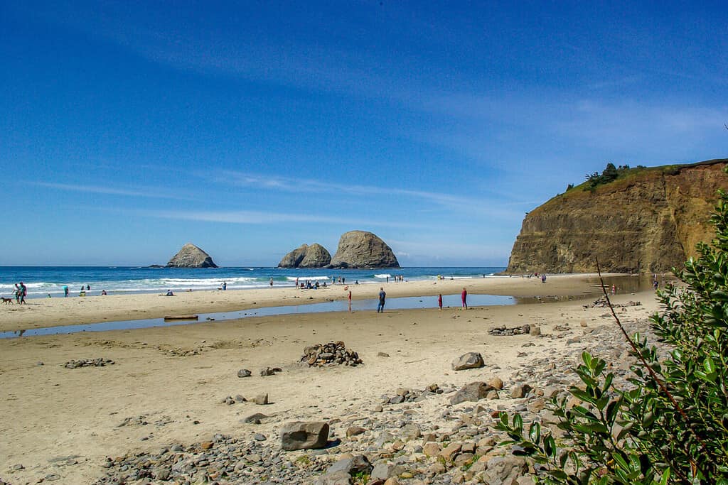 Landscape of tourists playing on Rockaway Beach on the Oregon coast near Tillamook