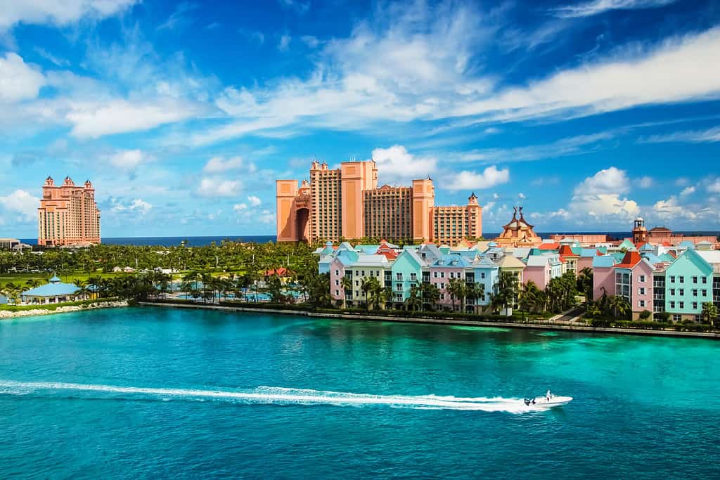 Beautiful scene of speed boat, ocean, colorful houses and a hotel in Nassau, Bahamas on a summer sunny day