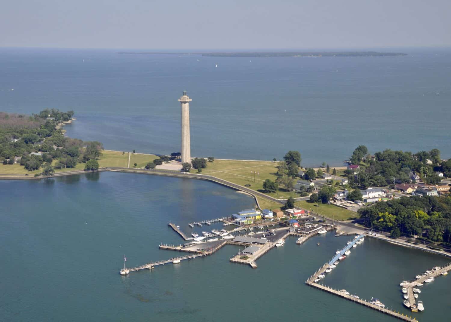 aerial view of Put in Bay's marina and Perry's Victory & International Peace Memorial, Kelley's Island in the far background; Put-in-Bay, South Bass island Ohio USA
