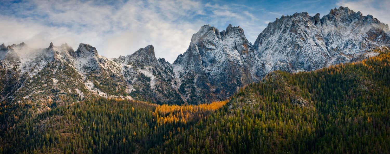 Washington Pass Along the North Cascades Highway During the Autumn Season. Larch trees and snow on the hills signal the approach of winter in the North Cascade Mountain range.