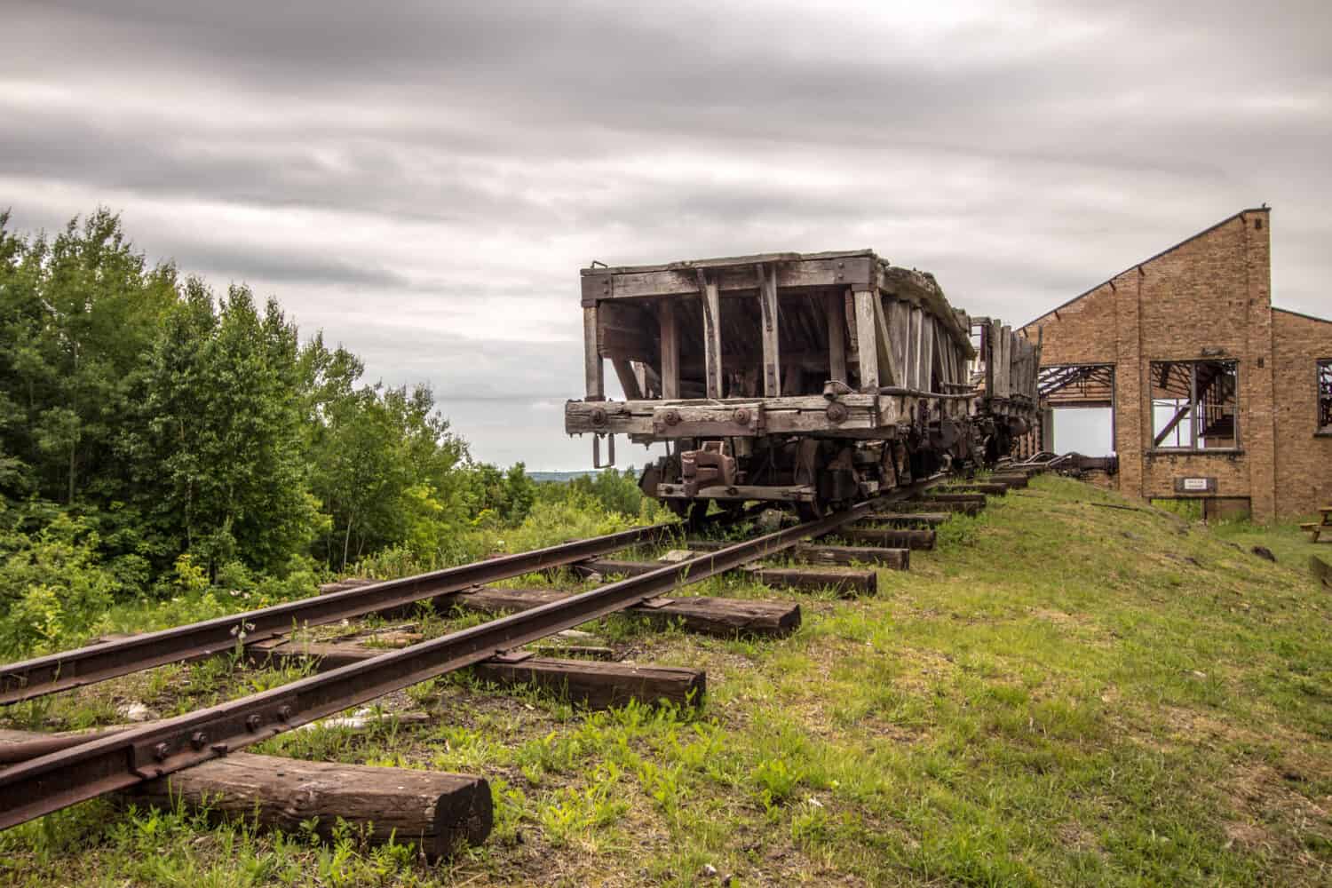 End Of The Industrial Era. Antique wooden train on the tracks at the Quincy Mine in the Keweenaw National Historical Park in Calumet, Michigan