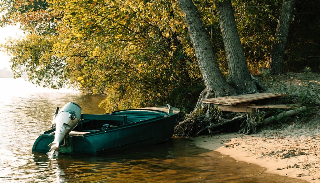 Golden autumn in New England. Boat on the shore of the autumn lake