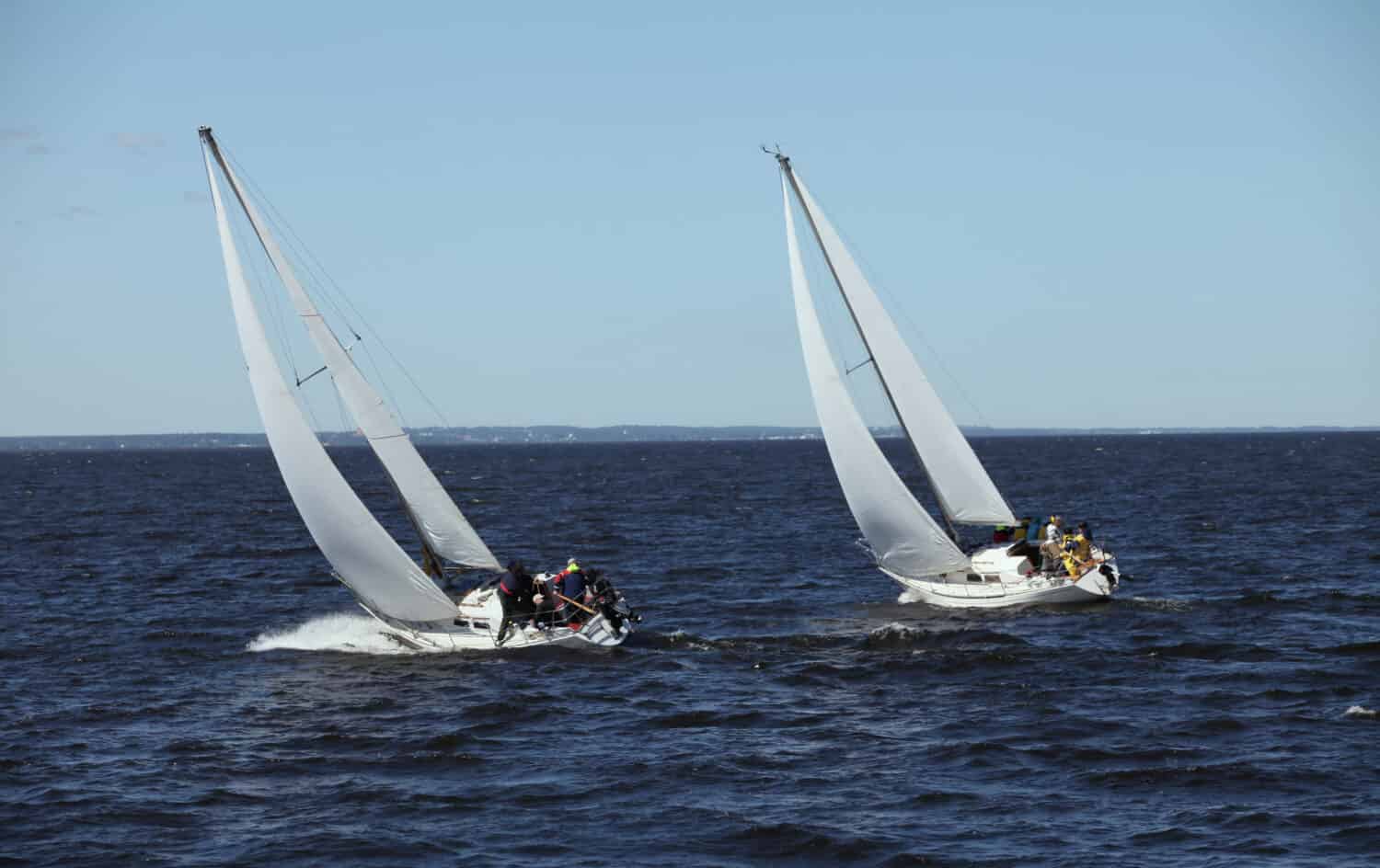 The wind at their back, sailors ride the tailwind, leveraging its favorable direction to sail swiftly and smoothly across the waters.