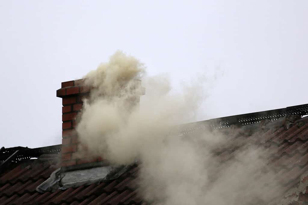 Smoke from the chimney of a house fueled with coal