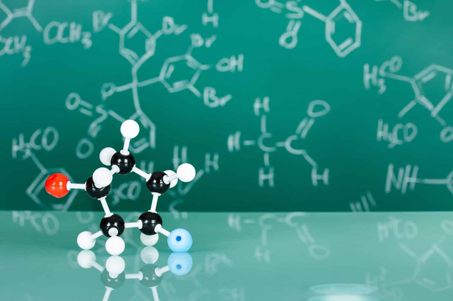 Model of molecular structure on green reflective background