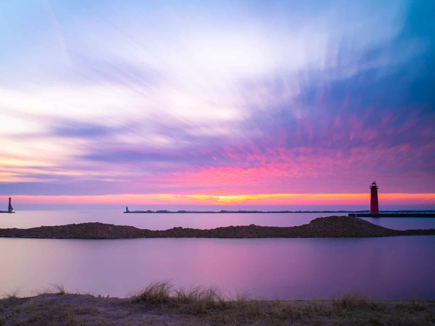 Beautiful sunset over the lighthouse in Muskegon Michigan at the beach