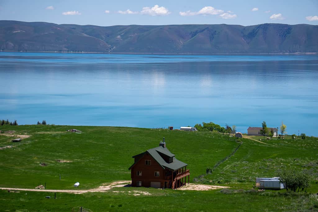 View of Bear Lake on the Idaho side with cabin facing the lake on the hillside.