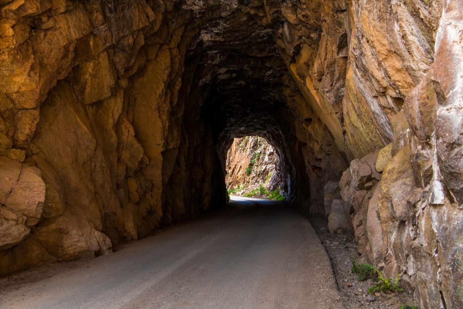 Tunnel and road curving through red rock sandstone - Gilman Tunnels near Jemez Springs in northern New Mexico