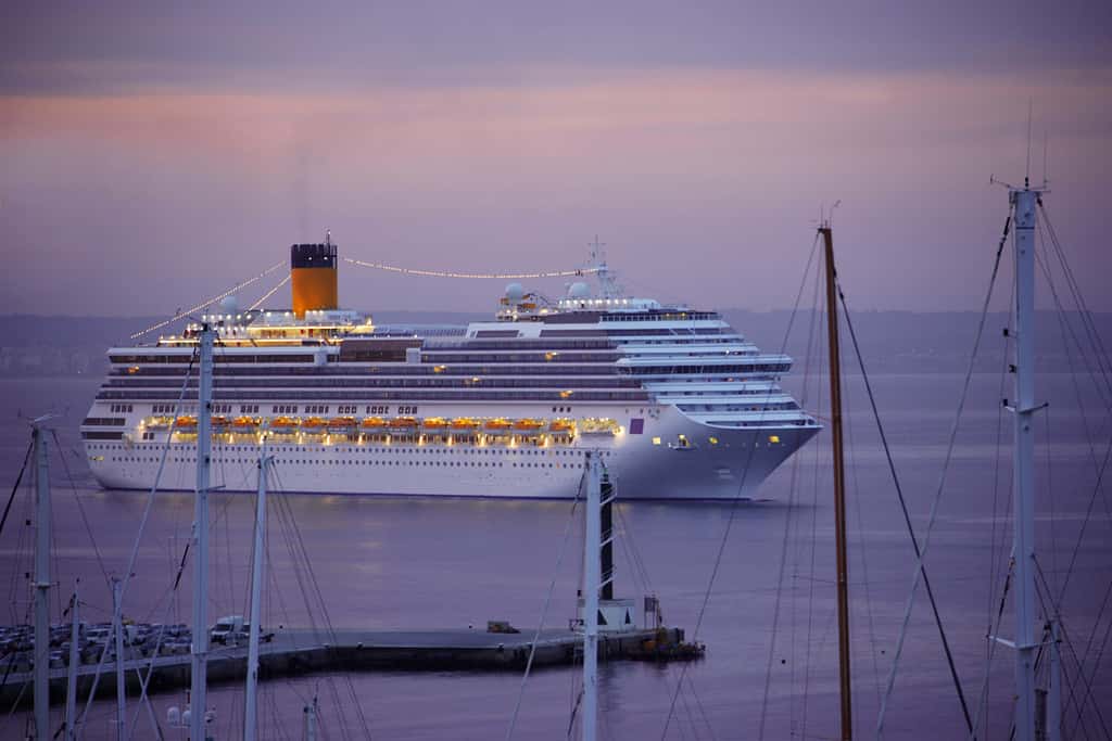 Cruise Ship arriving at the harbor of Palma de Mallorca at sunrise, Mallorca, Spain