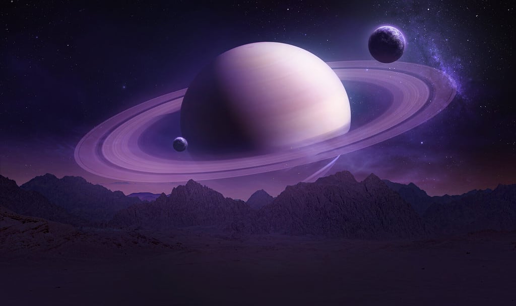 Sci-fi wallpaper of Saturn planet and mountains in the Earth. Night landscape. Elements of this image furnished by NASA