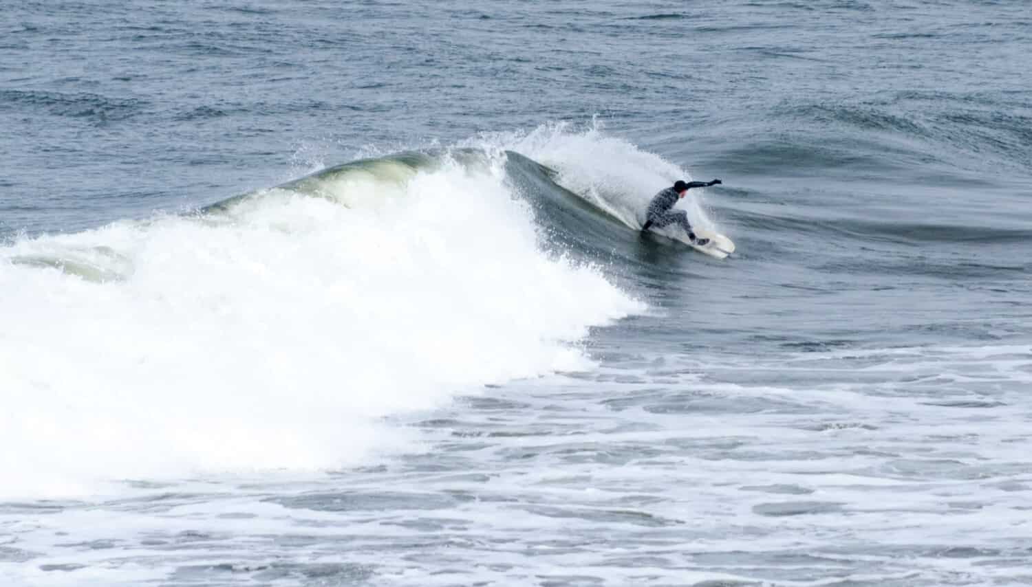 A surfer rides a large wave in Grays Harbor, Washington.