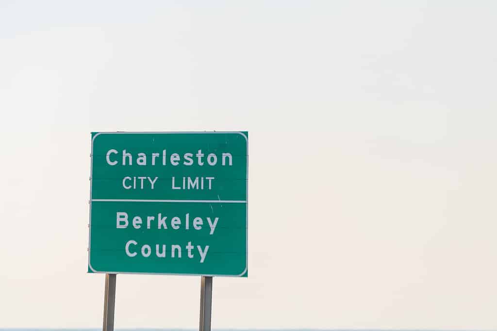 Charleston, USA welcome to city green sign on highway road street with sky in background and text for city limit Berkeley county in South Carolina