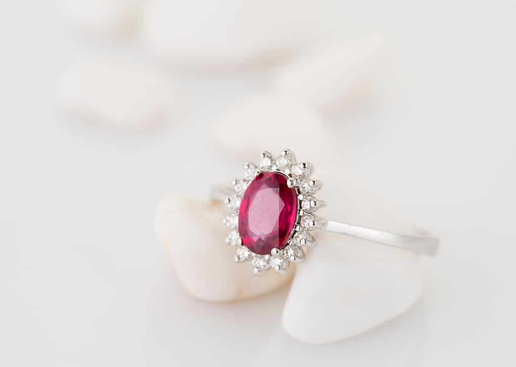 Red topaz (ruby) diamond ring on a white soft background.