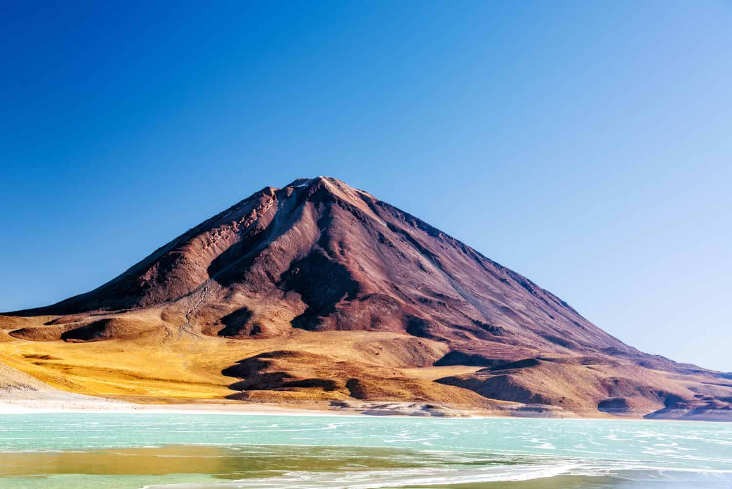 View of Licancabur Volcano and the emerald green Laguna Verde on the border of Chile and Bolivia