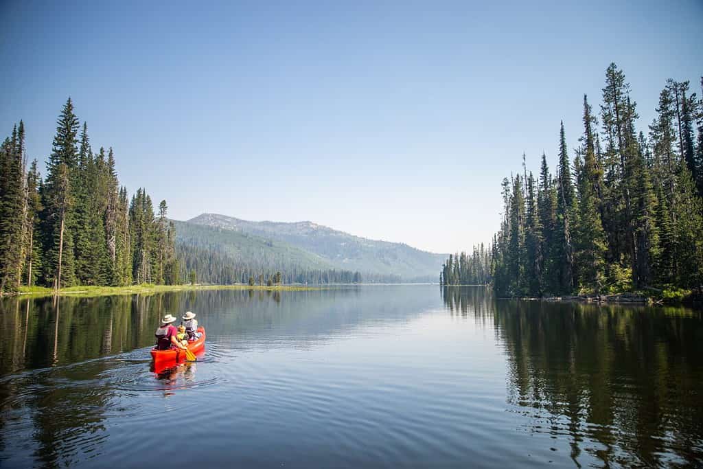  A couple in a kayak, enjoying the beauty of nature on a lake 