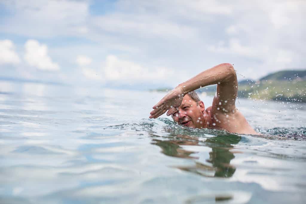  A person swimming in a lake. 