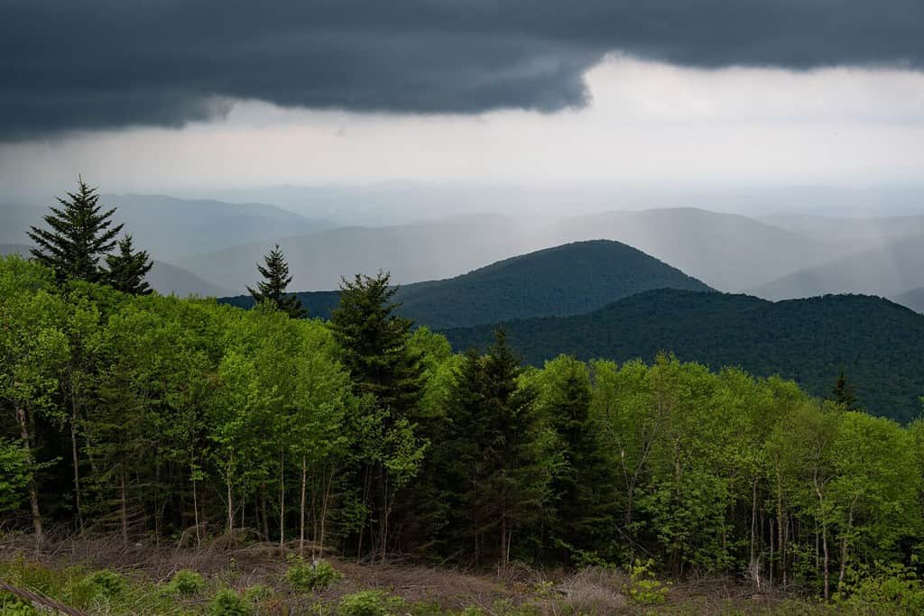 A view of the Green Mountain Nation Forest in Vermont as dark clouds bringing rain roll in.