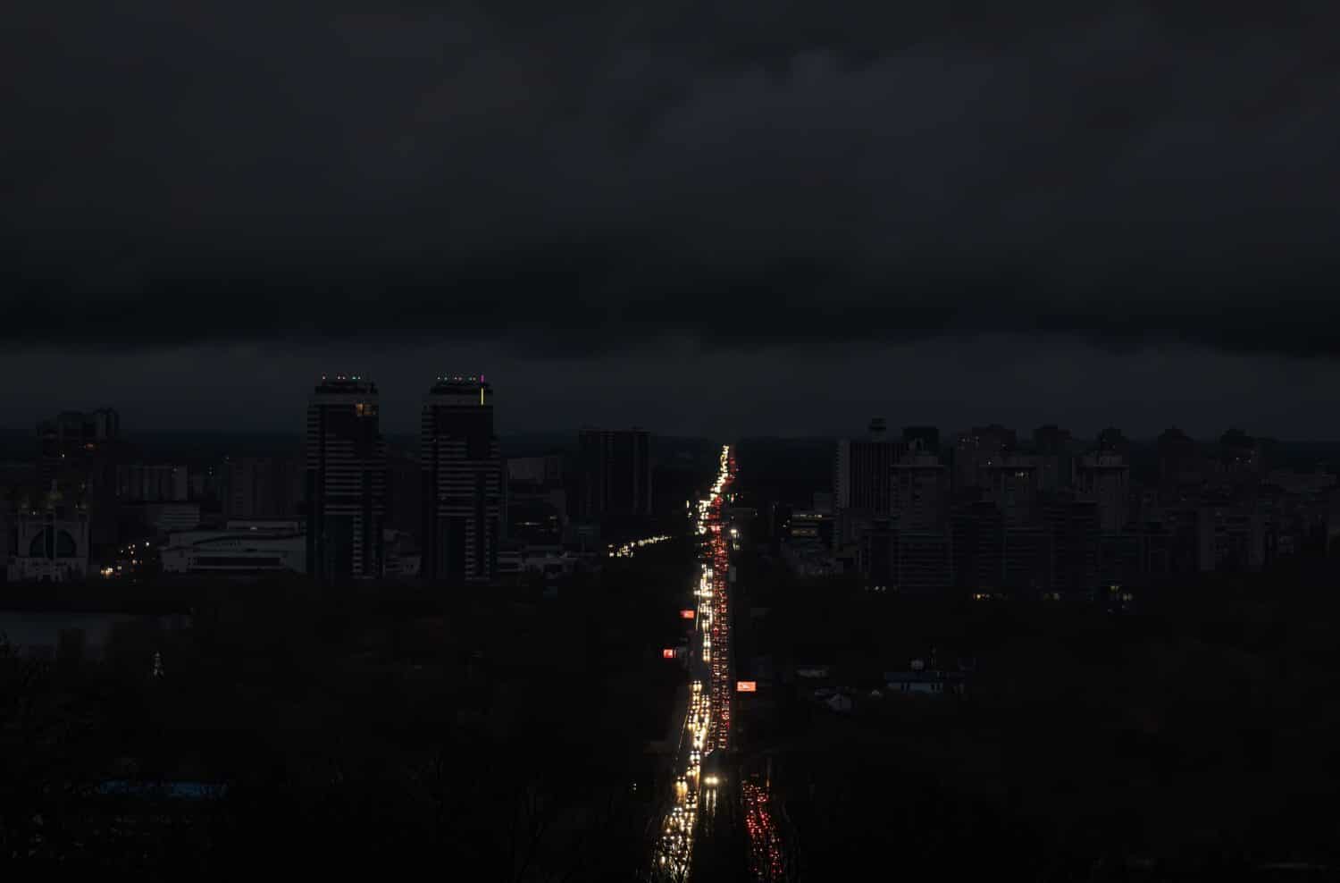 Blackout in the Ukrainian capital Kyiv. Capital streets without street lighting. Only the lights of passing cars are visible.