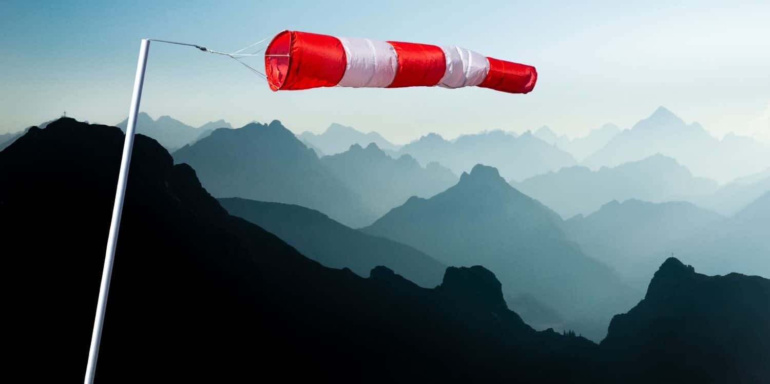 A forceful headwind driving the windsock, highlighting the strong and opposing current that challenges the surrounding environment.