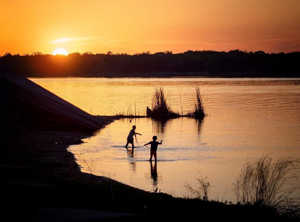 Sunset Silhouette - this is my another all time favorite to shoot. We had a camping trip in Lake Murray Oklahoma. Two boys were playing in the lake. Sunset in distance.