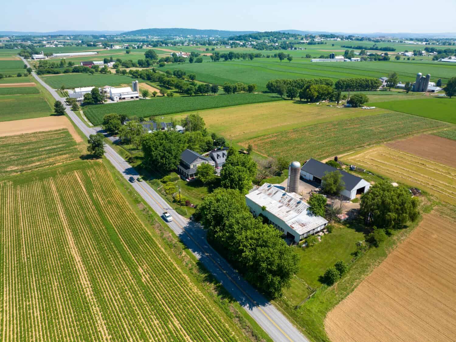 An aerial view of a farm surrounded by the lush green fields in Lancaster County, Pennsylvania.