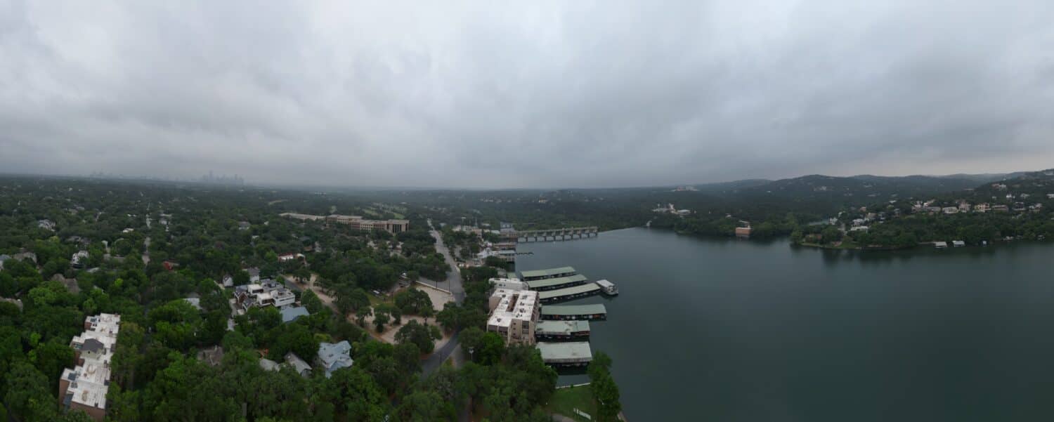Lake Austin, Tom Miller Dam, and the hills of west Austin Texas on an overcast, hazy morning.