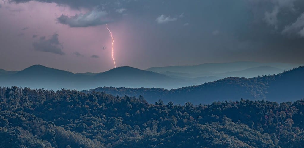 A lightning strike over the layered misty hills viewed from the blue ridge parkway, North Carolina