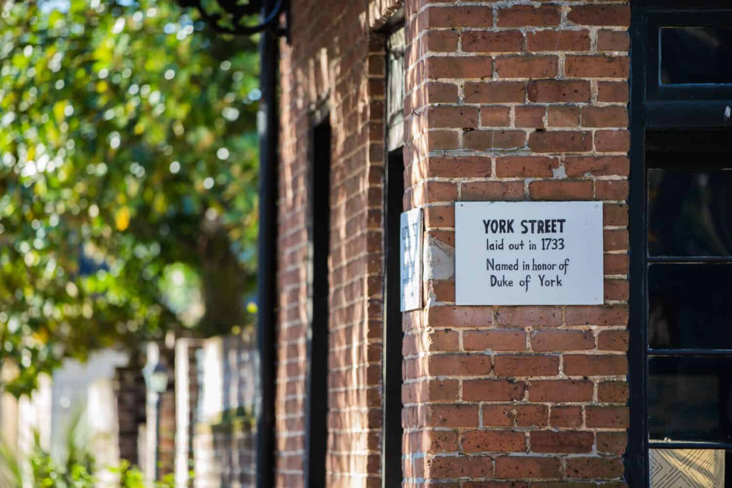 A street marker on the brick with York Street laid out in 1733 named in honor of Duke of York text