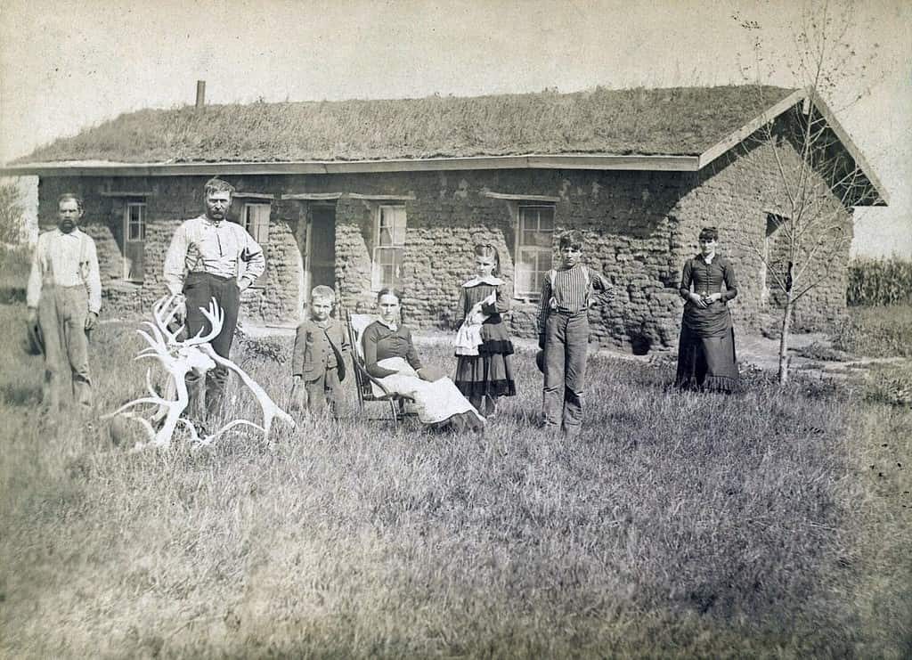 Morrison family in front of sod house in Custer County, Nebraska in 1886. Lumber was scare and sod dwellings were the first home for many pioneers.